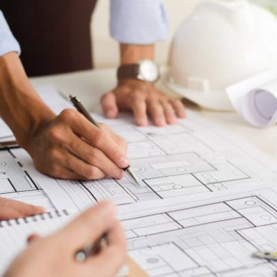 Close-up of an engineer planning a hand-drawn design. with architect equipment Architects talking at the table Teamwork and workflow concepts