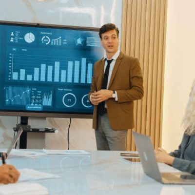 Presentation in office or ornament meeting room with analyst team utilize BI Fintech to analyze financial data. Businesspeople analyzing BI dashboard power display on TV screen for strategic planning